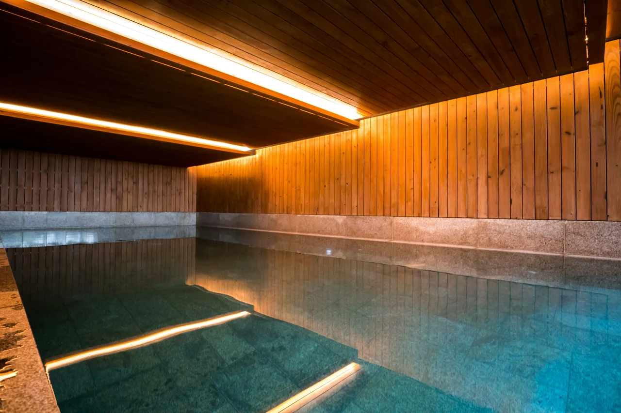 An indoor pool with timber walls and ceiling
