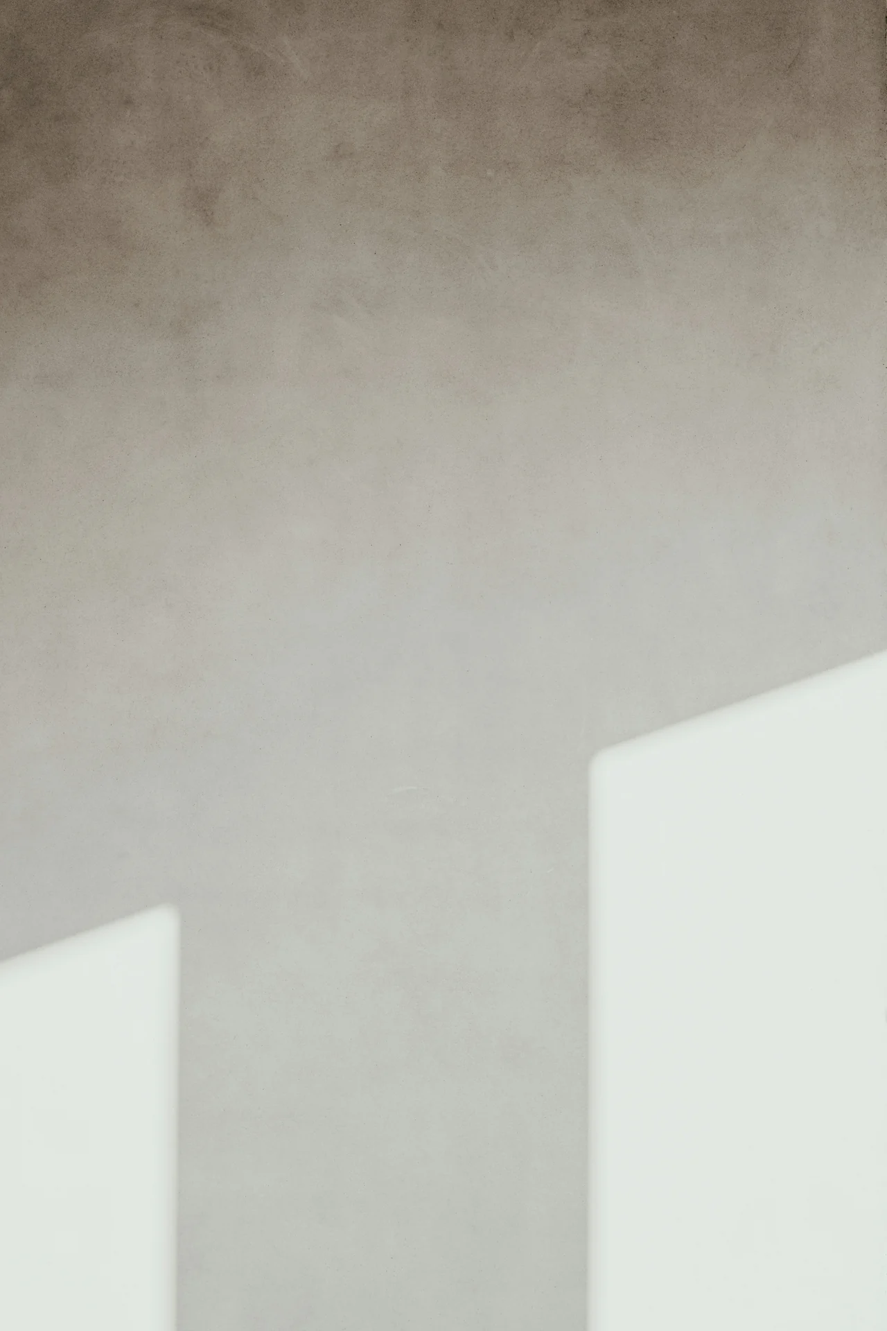 Sunlight and shadow on a pale wall